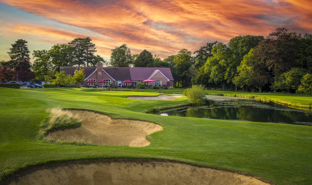 18th hole at aldwickbury park golf club in harpenden next to the clubhouse and the lake