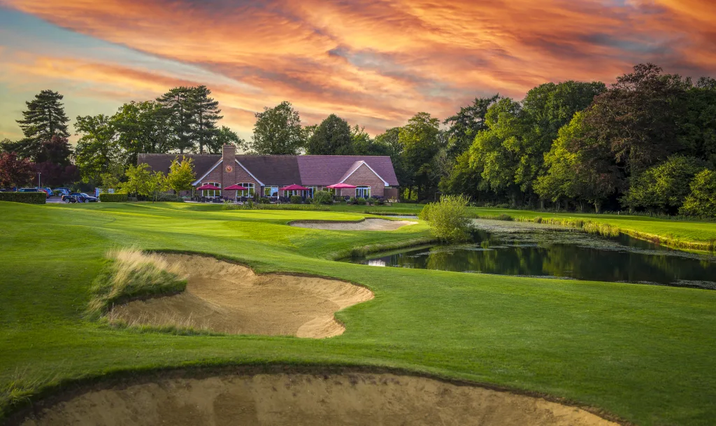 18th hole at aldwickbury park golf club in harpenden next to the clubhouse and the lake