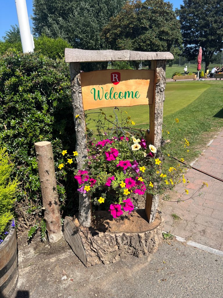 handmade welcome sign at a sustainable golf club
