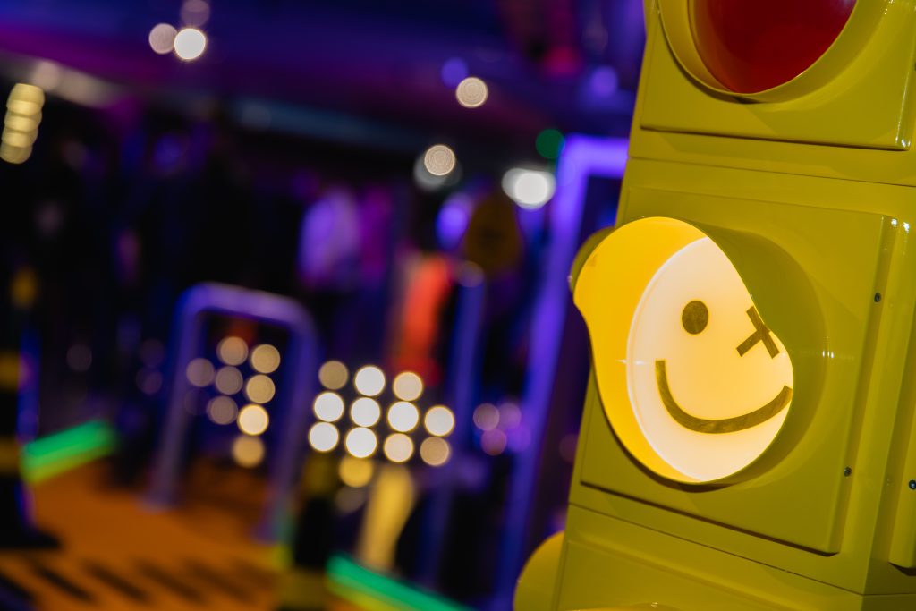 traffic light with smily face as the light at mini golf venue