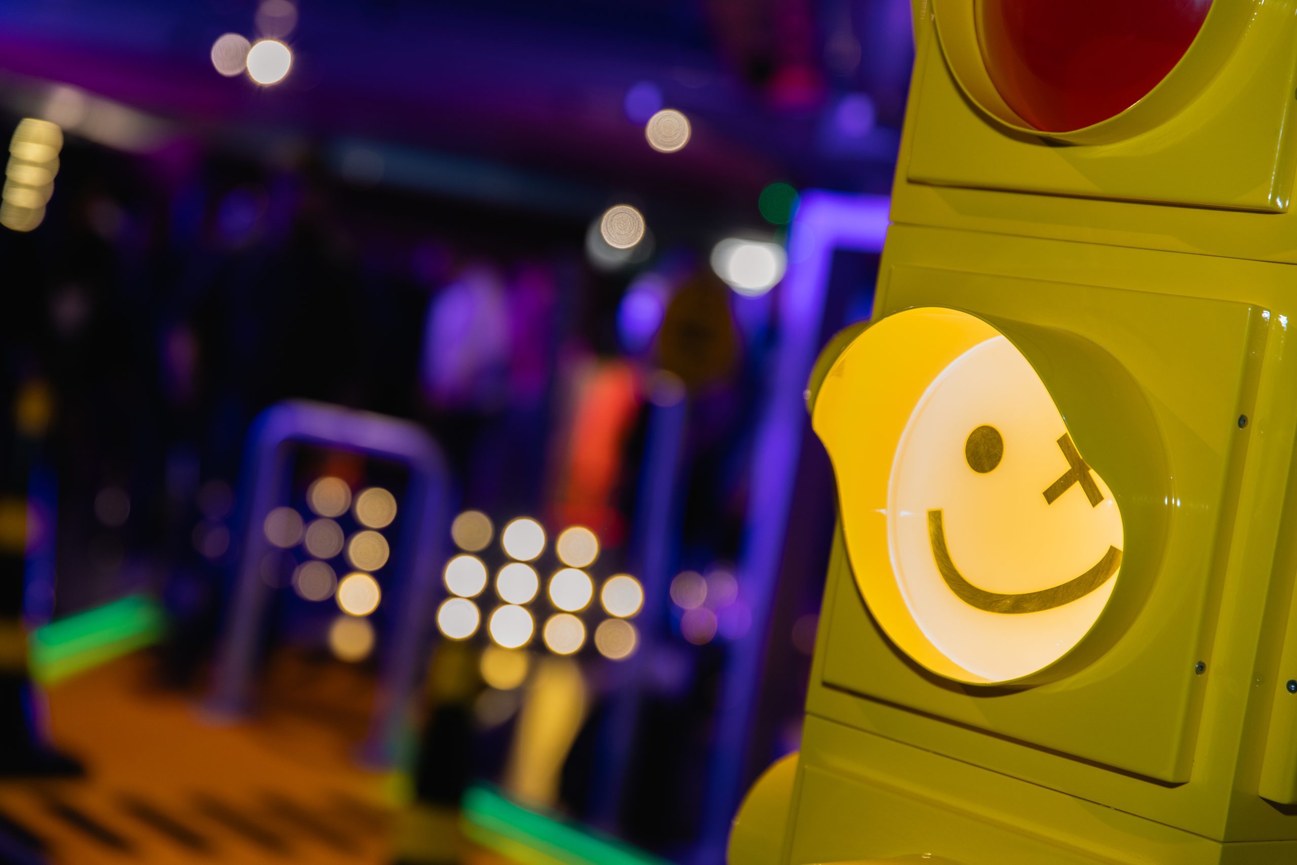 traffic light with smily face as the light at mini golf venue