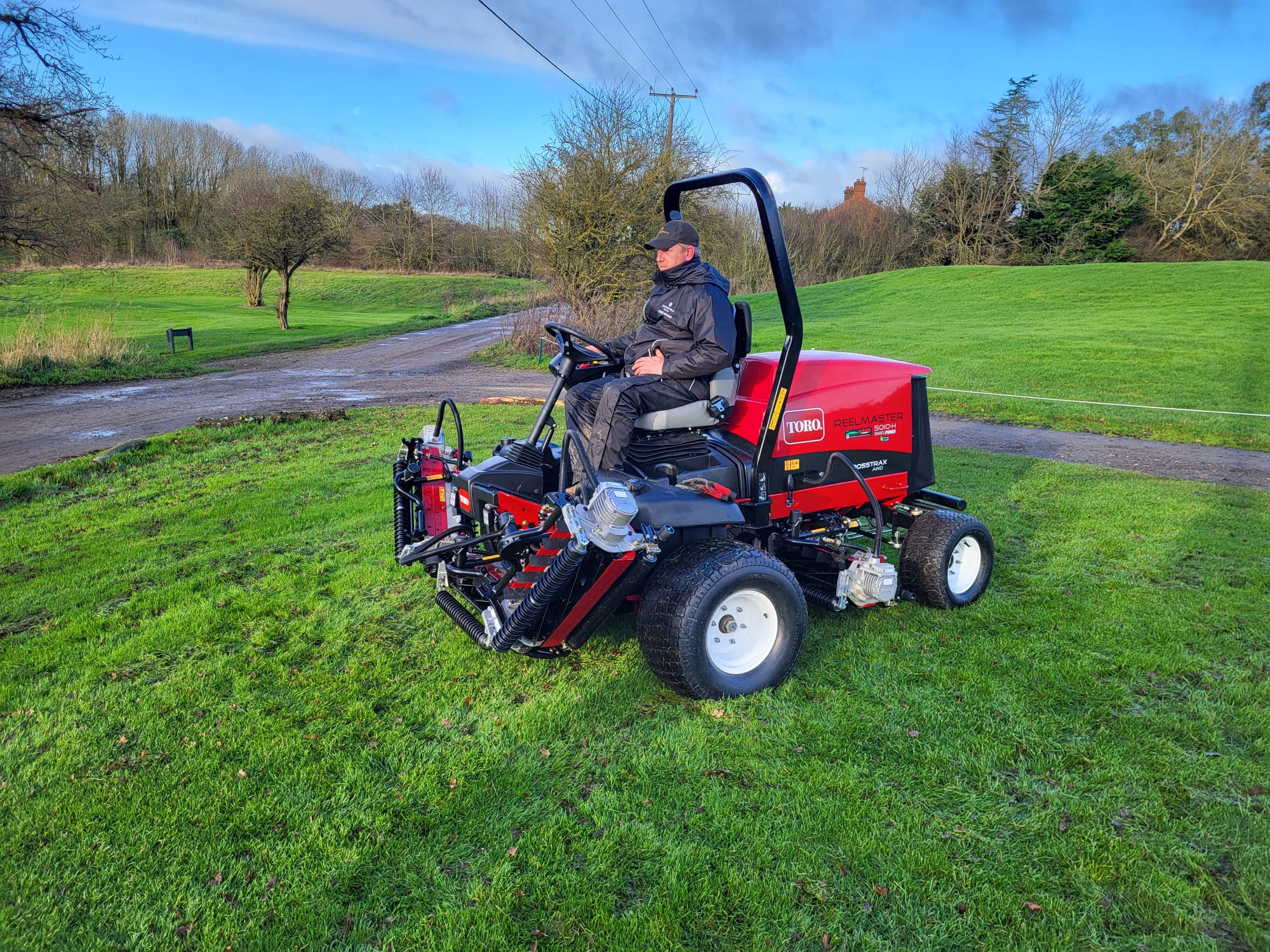 green keeper sat on mower at a sustainable golf course