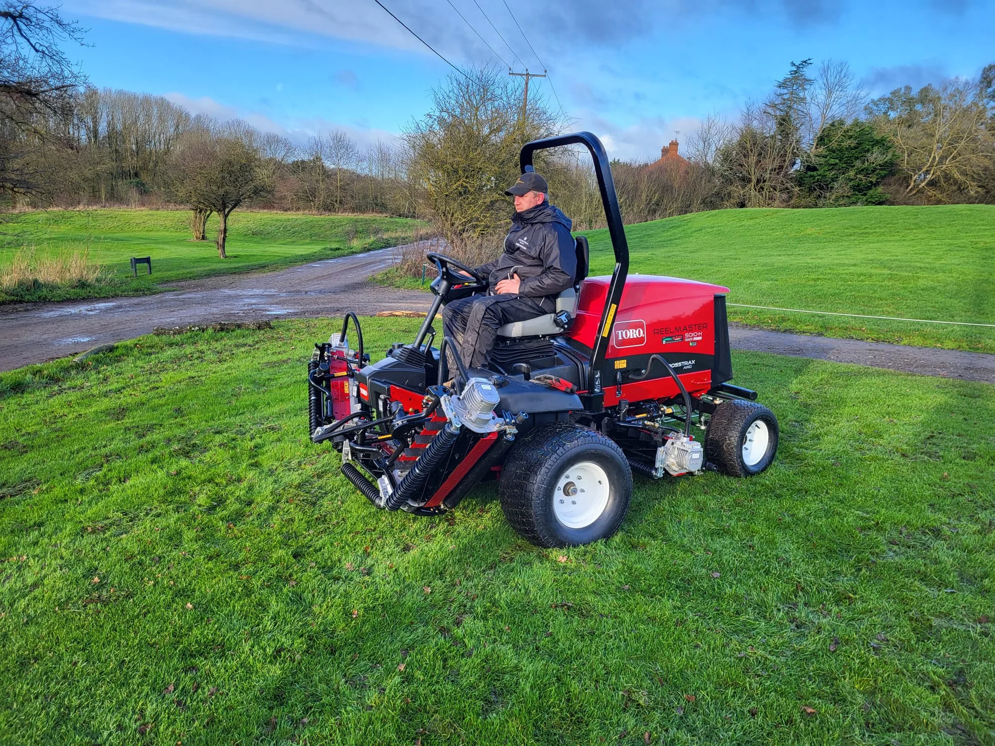 green keeper sat on mower at a sustainable golf course